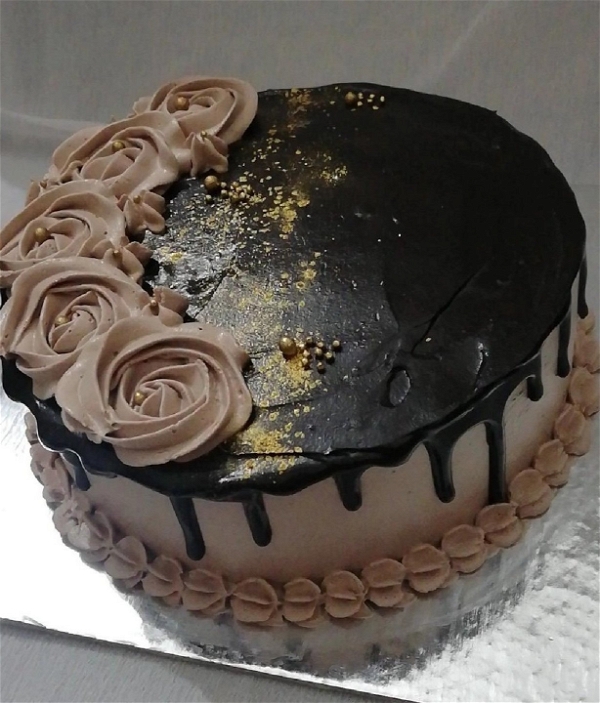 Deep Creamy Choclate Cake Topped With Golden Sprinkles And Semi Brown Flowers - 2 Pound